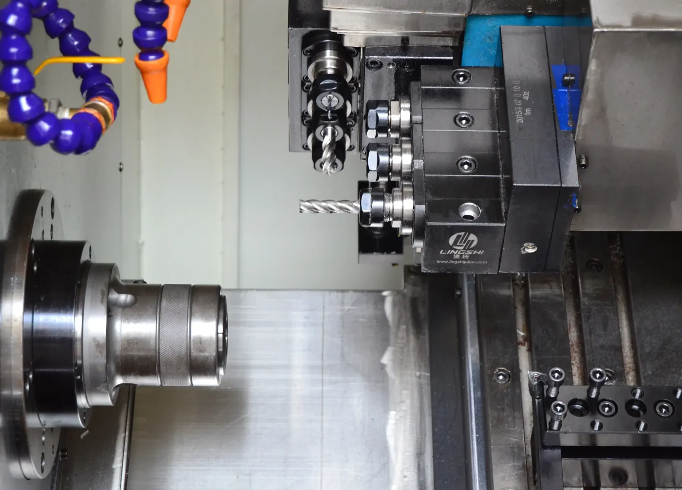Gang-tool CNC lathe with live tooling and a knurled part in the collet, GY Machining
