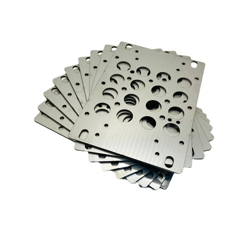 Batch of laser-cut steel mounting plates with holes and slots